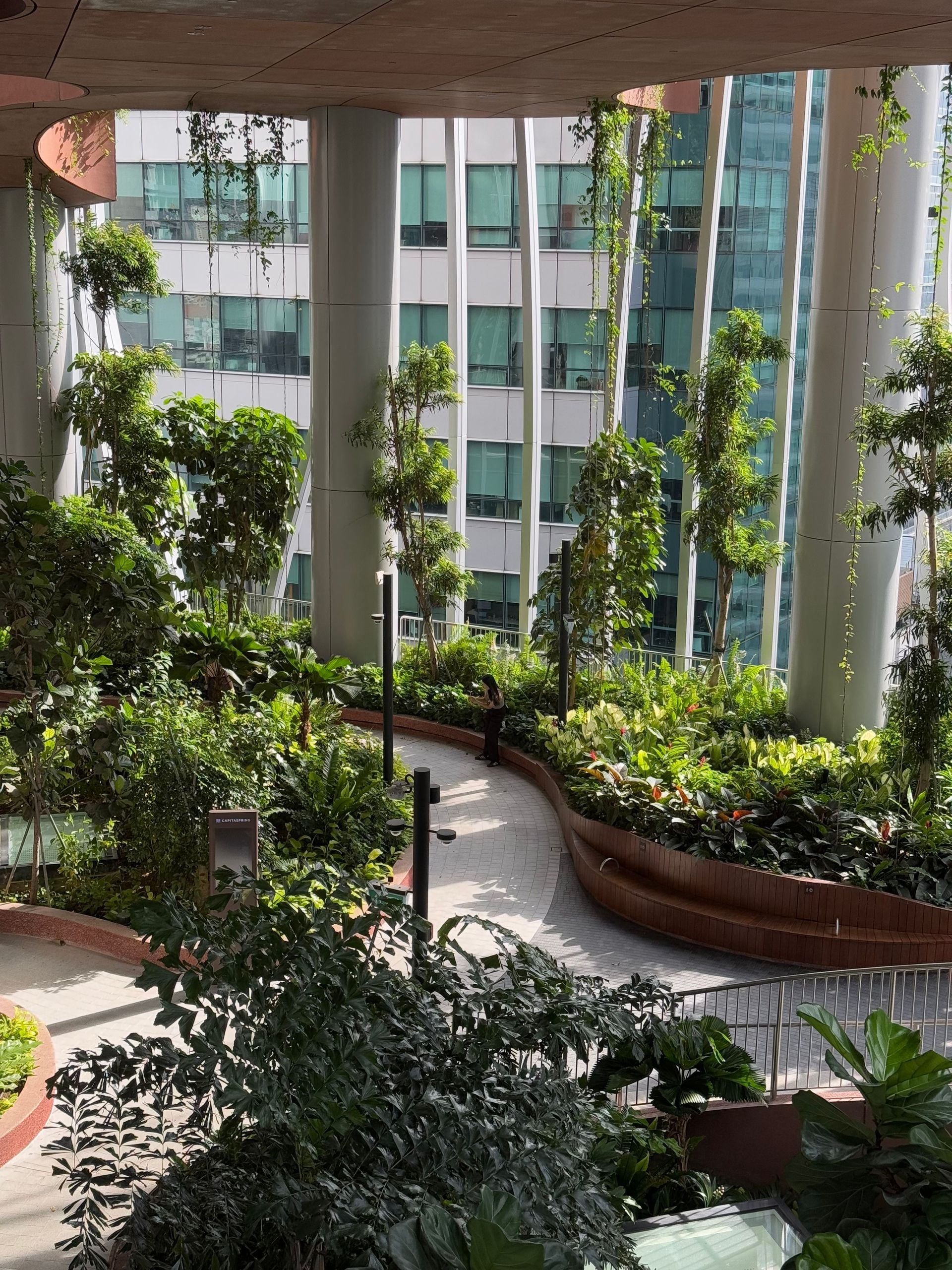 A vibrant vertical garden inside a modern building, showcasing urban greenery and architecture.